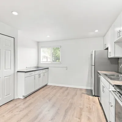 Renovated kitchen with white cabinets at Lime Apartments