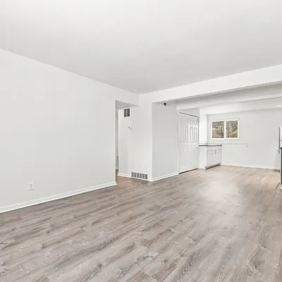 Open living room looking toward the kitchen at Lime Apartments